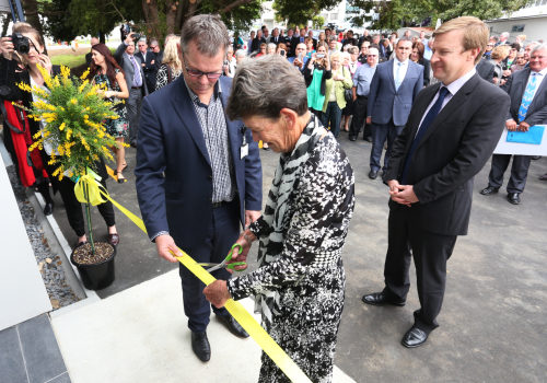 Mrs Carney cutting the ribbon 