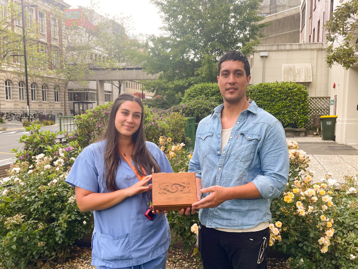 Dr Waimarama Matena and Dr Josh Solomon hold one of the Ipu Mārie, showing the kowhaiwhai engraving on top.