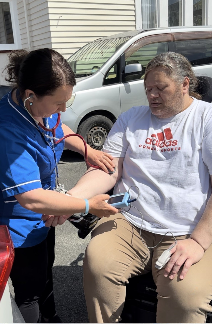 community nurse check patient blood pressure