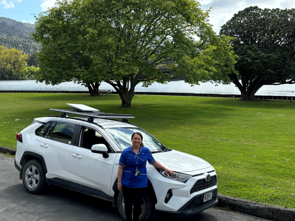 Nurse standing in front of park Starlink car